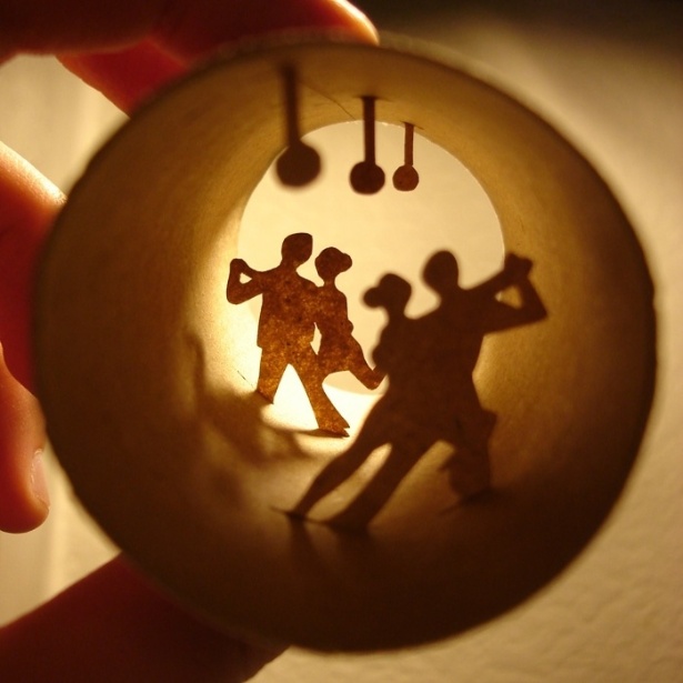 As cenas são montadas com recortes de papel similar ao papel de que é feito o rolo. Depois, elas são cuidadosamente colocadas dentro dos canudos. Na foto, casais dançam tango - Anastassia Elias