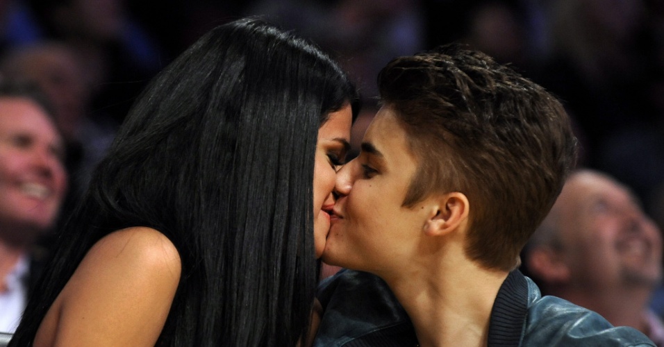 Aos beijos, Justin Bieber e a namorada Selena Gomez assistiram ao jogo do Los Angeles Lakers contra o San Antonio Spurs em Los Angeles, na Califórnia (17/4/12)