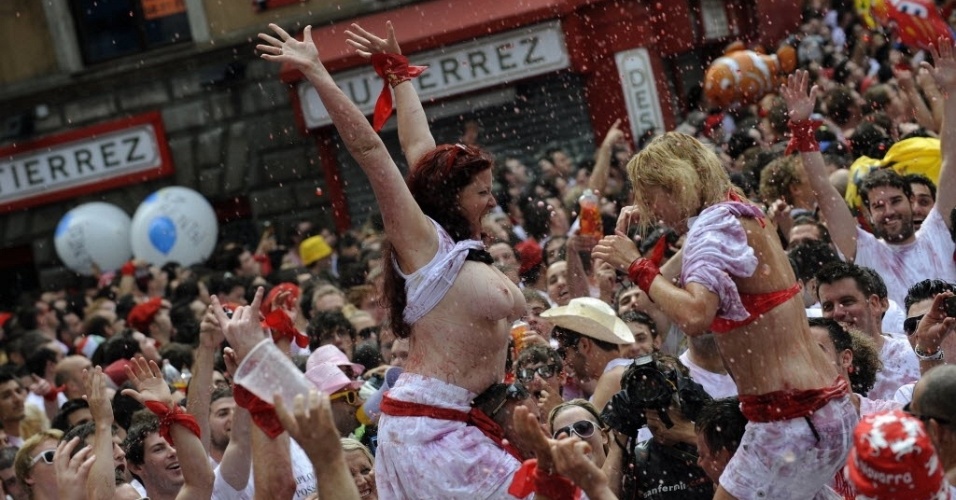 6.jul.2012 - Encharcados de vinho e, em alguns casos, seminus, foliões comemoram o 1 dia da festa de São Firmino na cidade de Pamplona, na Espanha