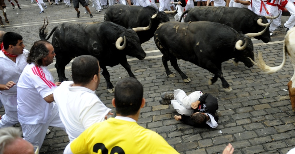 11.jul.2012 - Participante da Festa de São Firmino cai em frente aos touros em Pamplona, na Espanha, nesta quarta-feira (11)