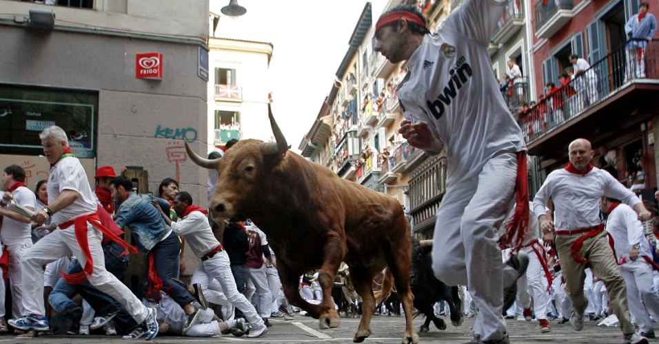 14.jul.2012 - Espanhóis correm de touro neste sábado (14), durante o oitavo e último dia da festa de São Firmino, em Pamplona, na Espanha