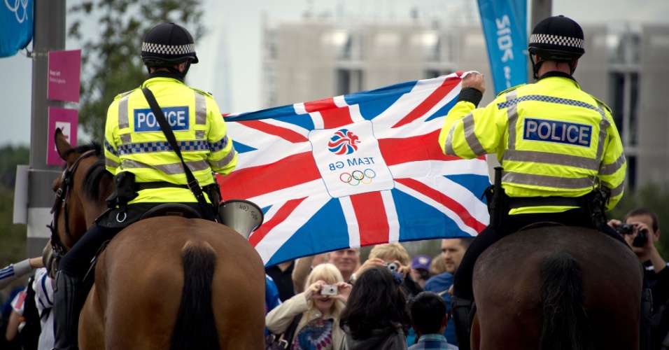 Policiais posam com bandeira do Reino Unidos entre visitantes no Parque Olímpico de Londres