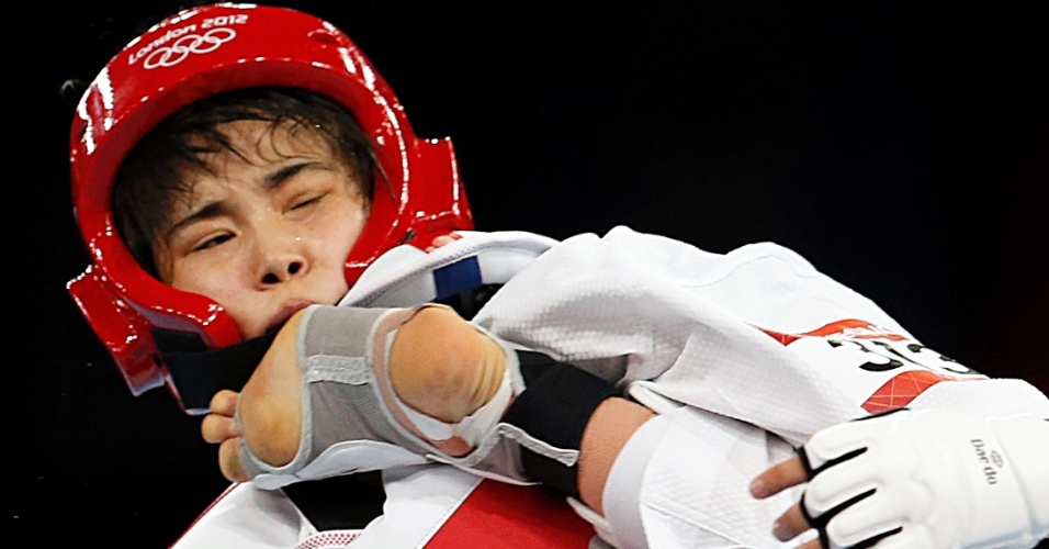 Neozelandesa Robin Cheong leva um chute no rosto da egípcia Hedaya Wahba, durante a disputa da categoria até 57 kg