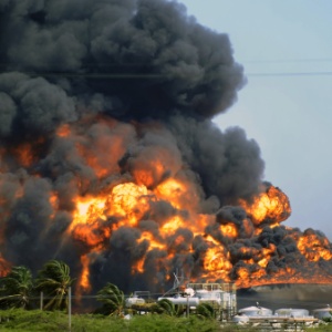 Tanque da refinaria de Amuay, em chamas um dia após a explosão - Leo Ramirez/AFP