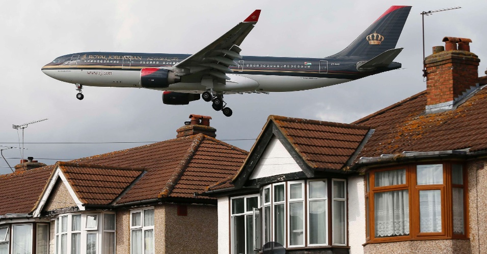 28.ago.2012 - Avião sobrevoa casas, perto do aeroporto de Heathrow, na Inglaterra