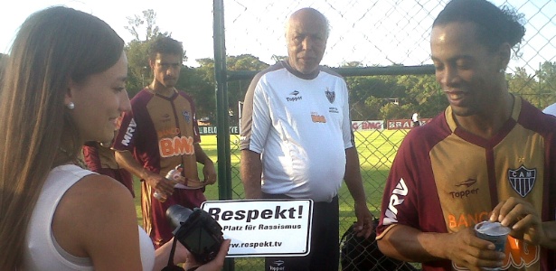 Jornalista Paula Widmer mostra a placa com dizeres contra racismo a Ronaldinho - Bernardo Lacerda/UOL