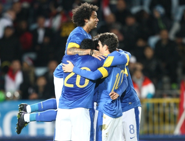 Jogadores da seleção brasileira abraçam o meia Oscar, que abriu o placar para a equipe no amistoso com o Iraque