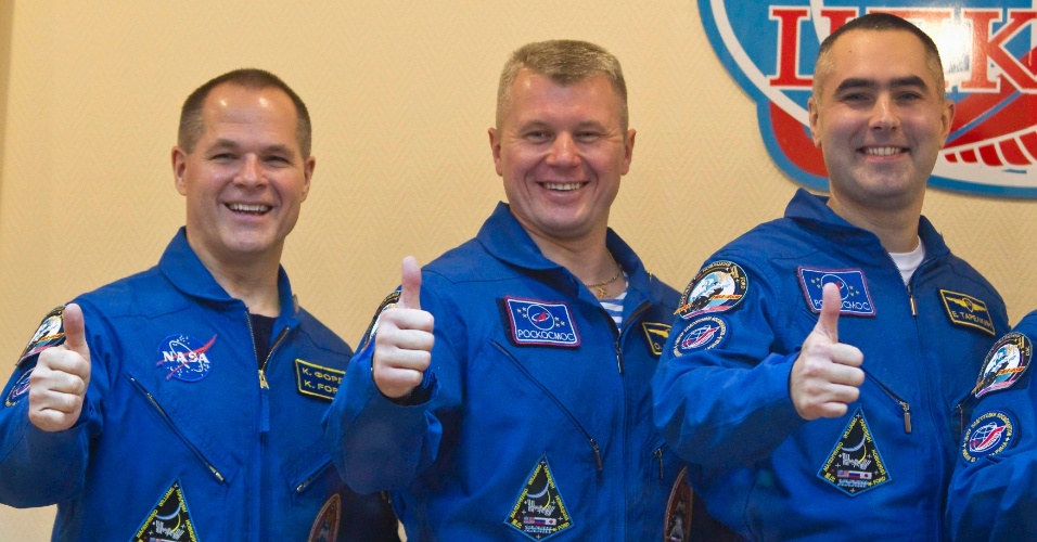 22.out.2012 - Os próximos tripulantes da Estação Espacial Internacional (ISS, na sigla em inglês) cumprimentam jornalistas no cosmódromo de Baikonur, no Cazaquistão, nesta segunda-feira (22). O norte-americano Kevin Ford (à esquerda) e os russos Oleg Novitskiy (centro) e Evgeny Tarelkin viajarão ao espaço nesta terça-feira (23)