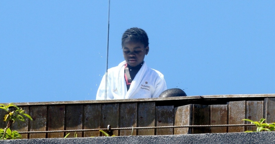 30.nov.2012 - Com um roupão branco, Mercy, filha de Madonna, aparece na piscina do hotel em que a comitiva da cantora está hospedada em Ipanema, no Rio