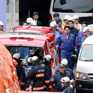 O ministro dos Transportes japonês, Yuichiro Hata, (ao centro) inspeciona o trabalho das equipes de resgate no túnel de Sasago nesta segunda-feira (3) - Jiji Press/AFP
