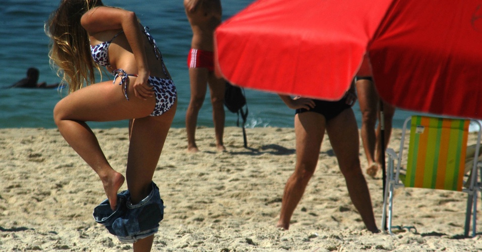 8.dez.2012 - Mulher se prepara para tomar sol na praia de Ipanema, na zona sul do Rio de Janeiro