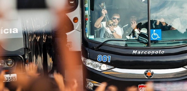 Dentro do ônibus, capitão Alessandro levanta a taça de Campeão Mundial - Leonardo Soares/UOL