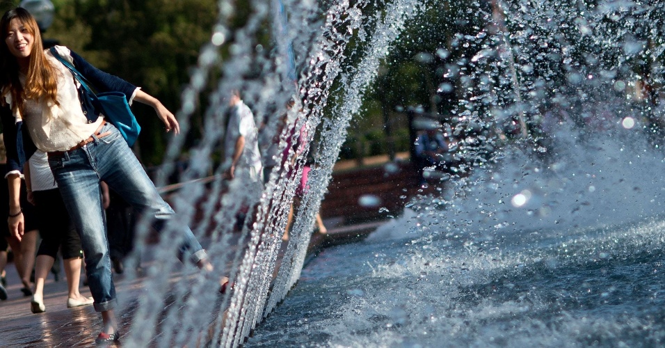 30.dez.2012 - Mulher passa ao lado de fonte no parque Tumbalong, em Sydney, na Austrália