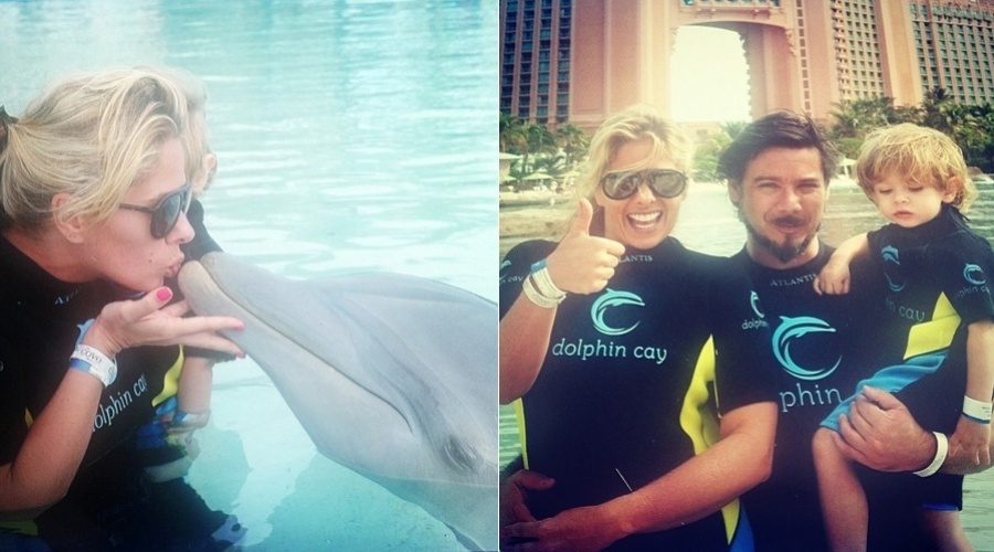 11.jan.2013 - Adriane Galisteu beijou um golfinho durante passagem por um parque aquático nas Bahamas