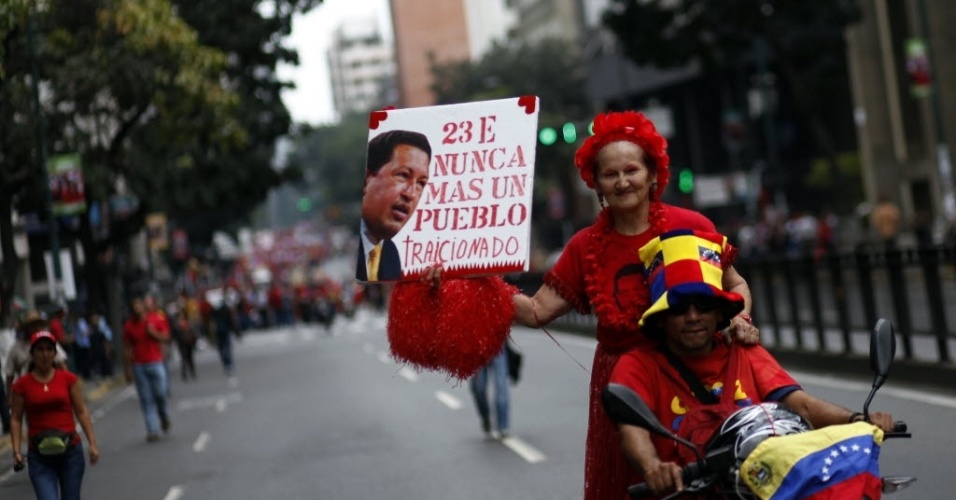 23.jan.2013 - Apoiadores do presidente venezuelano, Hugo Chávez, realizam uma marcha em Caracas, na Venezuela, para celebrar 55 anos de democracia no país, com a queda da ditadura de Marcos Pérez Jiménez (1952-1958), e homenagear o líder da Revolução Bolivariana, que se recupera de uma operação contra um câncer realizada em Cuba há um mês e meio