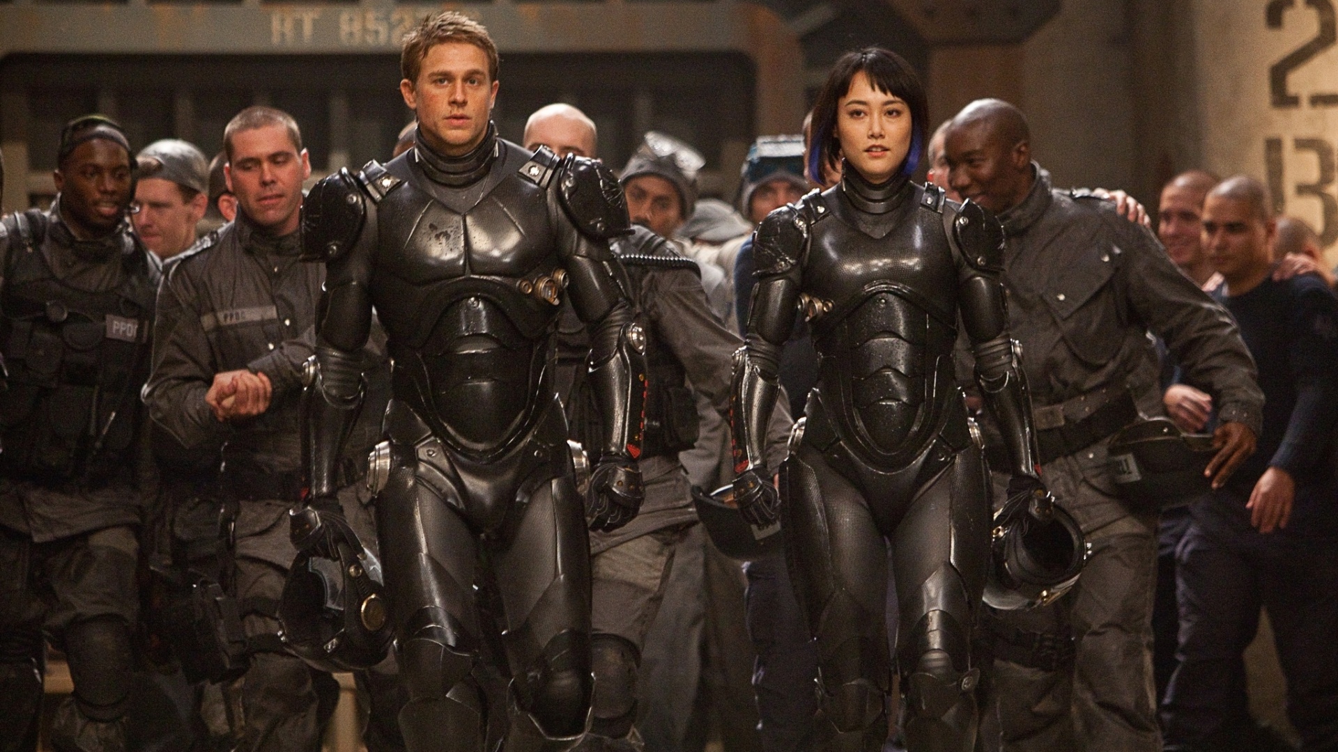 Charlie Hunnam é um ex-piloto que se une à novata interpretada por Rinko Kikuchi para formar uma equipe que pilotará um robô Jaeger para defender a humanidade contra as criaturas chamadas Kaiju; no novo longa de Guillermo del Toro, "Círculo de Fogo" - Divulgação