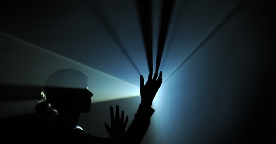 O trabalho "Eu e você, horizontal", de Anthony McCall's, é uma das instações ambientais imersivas da exposição. Usando um projetor de vídeo, uma máquina de neblina e linguagem de códigos de computador como meio, o trabalho é uma grande escultura feita de luz com a qual os visitantes podem interagir ao se moverem - Emma Lynch/BBC