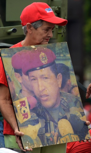 4.fev.2013 - Mulher exibe foto antiga do presidente venezuelano, Hugo Chávez, durante marcha realizada pelas ruas de Caracas, na Venezuela, em comemoração aos 21 anos da tentativa de golpe militar que o líder comandou, quando era tenente-coronel das Forças Armadas