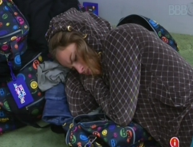 18.fev.2013 - Após toque de despertar, Natália dorme no chão da sala enquanto espera outros brothers irem no banheiro