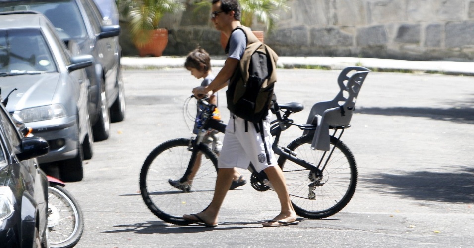 22.fev.2013 - Um dia depois de ter sofrido uma tentativa de roubo em sua casa, Wagner Moura passeia de bicicleta com seu filho Bem, de 5 anos, pelas ruas do bairro Humaitá, na Zona Sul do Rio de Janeiro
