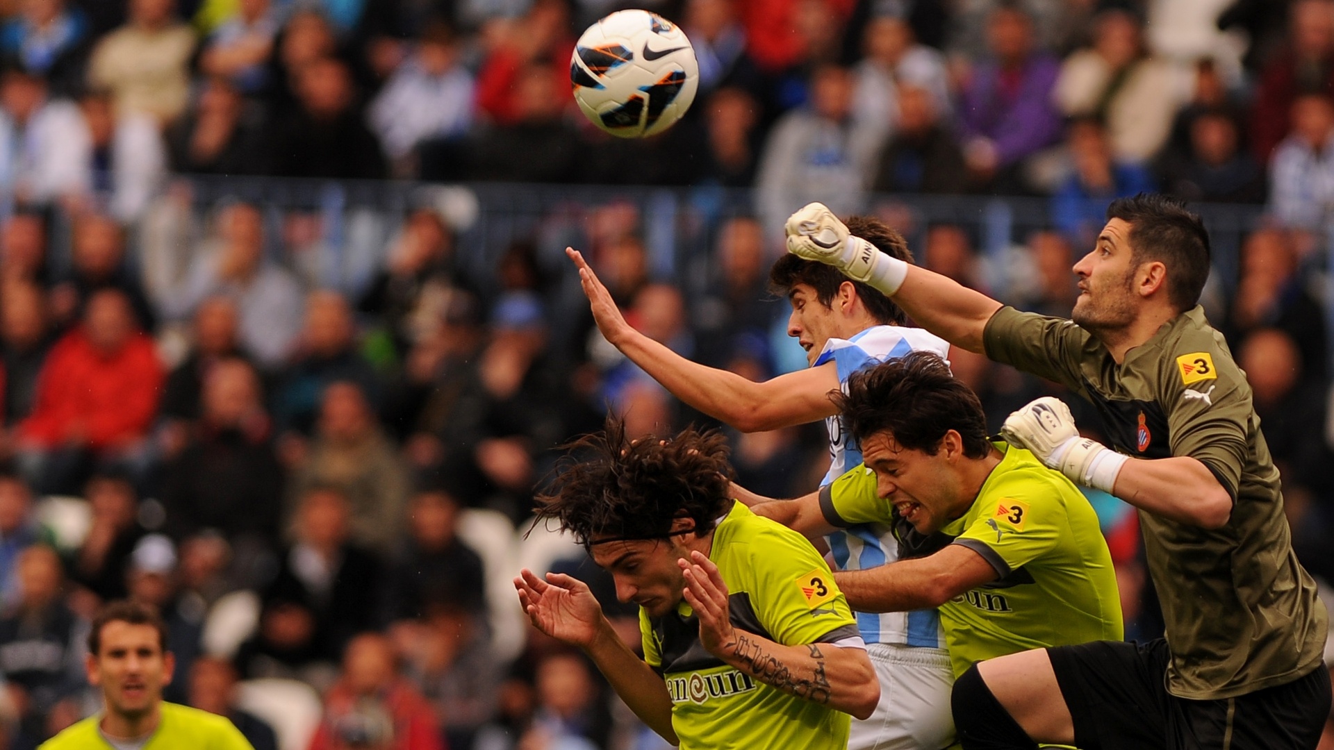 O atacante Lucas Piazon (ao centro) tentou, mas o Málaga saiu de campo com a derrota por 2 a 0 para o Espanyol - AFP PHOTO / JORGE GUERRERO