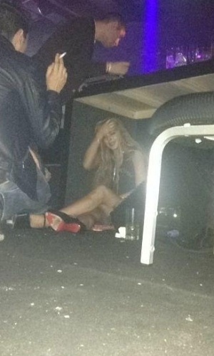 29.mar.2013 - Lindsay Lohan é flagrada se escondendo debaixo da mesa de DJ em casa noturna de São Paulo. Segundo o ex-BBB Serginho, que tirou a foto, ela não queria conversar com ninguém e fugiu do assédio no esconderijo improvisado