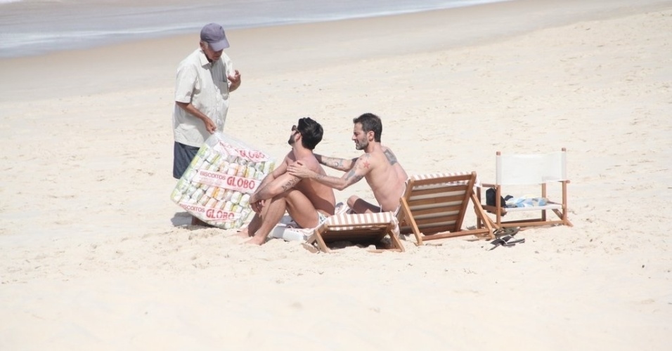 11.abr.2013 - O estilista Marc Jacobs passa bronzeador no namorado, o brasileiro Harry Louis, na praia de Ipanema, na zona sul do Rio