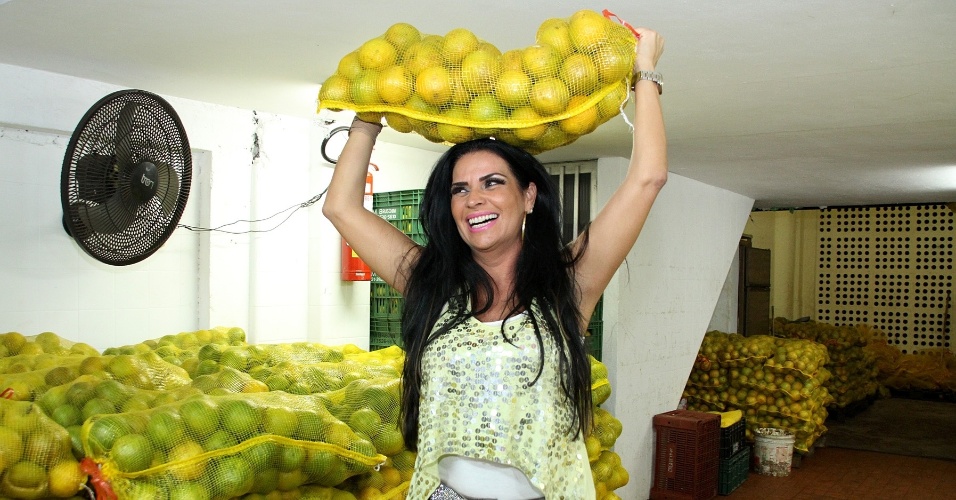22.abr.2013 - Solange Gomes carrega sacos de laranja no Cadeg, no Rio de Janeiro. A modelo viveu um dia de carregador de laranjas para o "Programa da Tarde", da Record