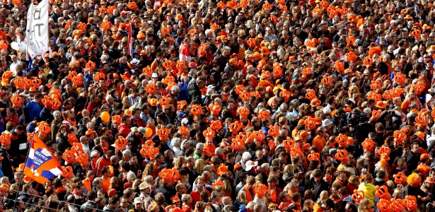 Multidão veste coroas laranjas ao se reunir na praça Dam, em Amsterdã, para se despedir da rainha Beatrix, que abdicou do trono, e saudar seu filho mais velho e agora rei da Holanda, William Alexander - Arie Kievit/Efe