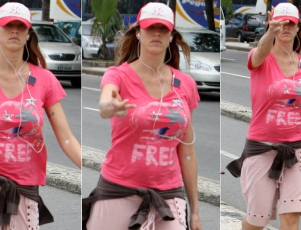 18.mai.2012 - A atriz Luana Piovani faz gesto com o dedo médio para paparazzo durante caminhada pela orla de Ipanema, na zona sul do Rio de Janeiro