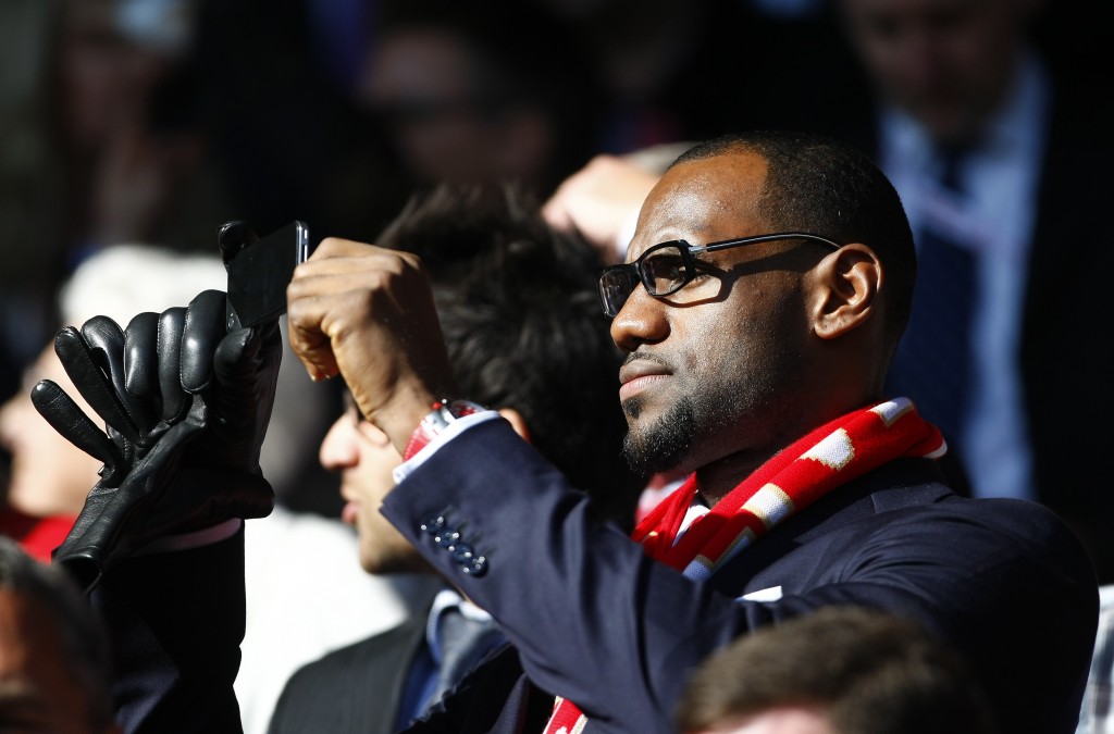 ORG XMIT: LTS108 U.S. and Miami Heat basketball player LeBron James looks on before the English Premier League soccer match between Liverpool and Manchester United at Anfield, Liverpool, England, Saturday Oct. 15, 2011. (AP Photo/Tim Hales)