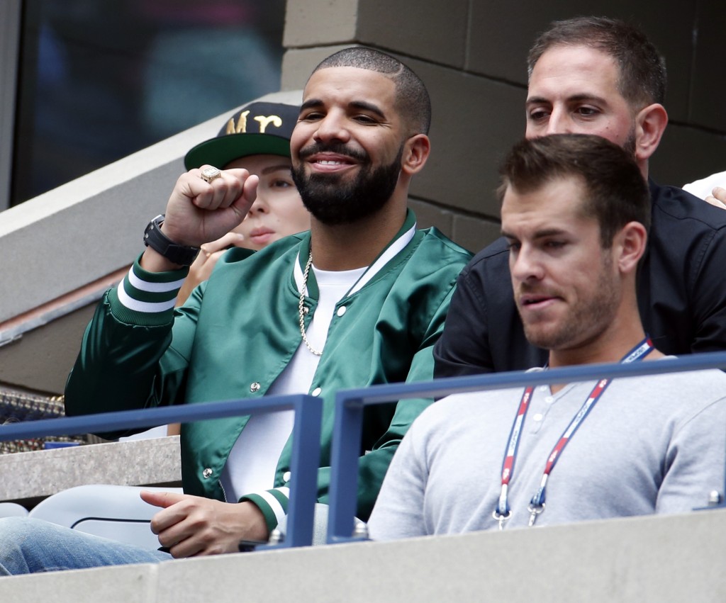 Recording artist Drake, left, cheers during a semifinal match between Roberta Vinci, of Italy, and Serena Williams at the U.S. Open tennis tournament, Friday, Sept. 11, 2015, in New York. (AP Photo/Julio Cortez) ORG XMIT: USO177