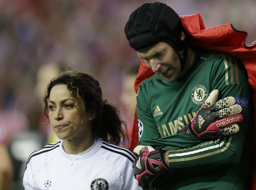 FILE - This is a Tuesday, April 22, 2014 file photo of Chelsea team doctor Eva Carneiro as she walks with Chelsea goalkeeper Petr Cech who holds his arm as he leaves the pitch following an injury during the Champions League semifinal first leg soccer match between Atletico Madrid and Chelsea at the Vicente Calderon stadium in Madrid, Spain. The Football Medical Association said Wednesday Sept. 23, 2015 that it is 