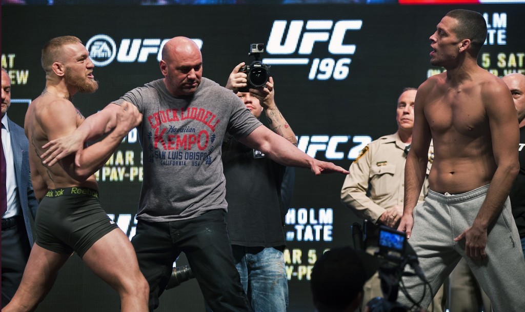 UFC welterweight Conor McGregor, left, is held back by Dana White while charging opponent Nate Diaz during the UFC 196 weigh ins at the MGM Grand Garden Arena in Las Vegas on Friday, March 4, 2016. (L.E. Baskow/Las Vegas Sun via AP) LAS VEGAS REVIEW-JOURNAL OUT; MANDATORY CREDIT ORG XMIT: NVLVS107