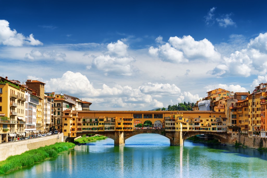 Medieval stone bridge Ponte Vecchio (Old Bridge) over the Arno River in Florence, Tuscany, Italy. View from the Ponte Santa Trinita. Florence is a popular tourist destination of Europe.