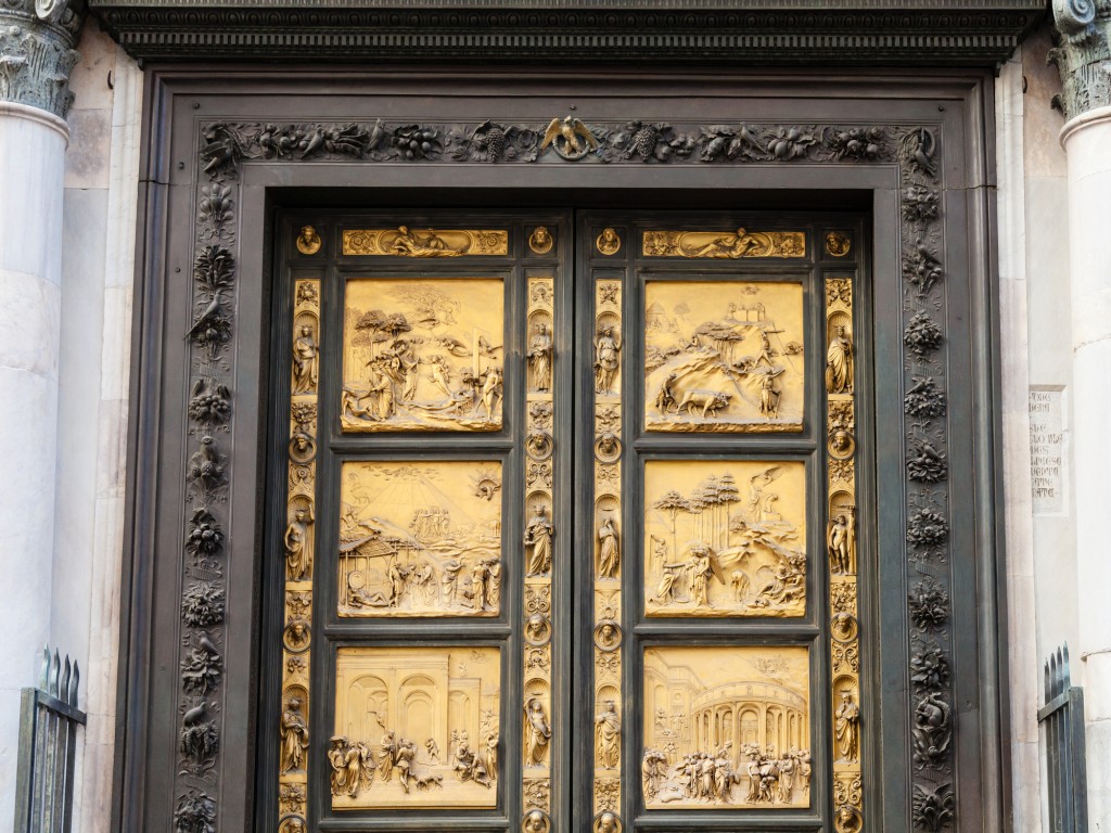 travel to Italy - closed outdoor East doors of Baptistery (Battistero di San Giovanni, Baptistery of Saint John), the doors are copy of Gates of Paradise made by Lorenzo Ghiberti in Florence city