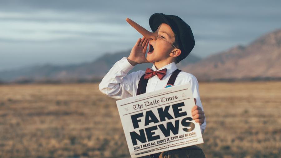 Old fashioned pinocchio news boy holding fake newspaper - 