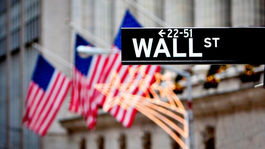 Sign of Wall Street with flags in the background - 