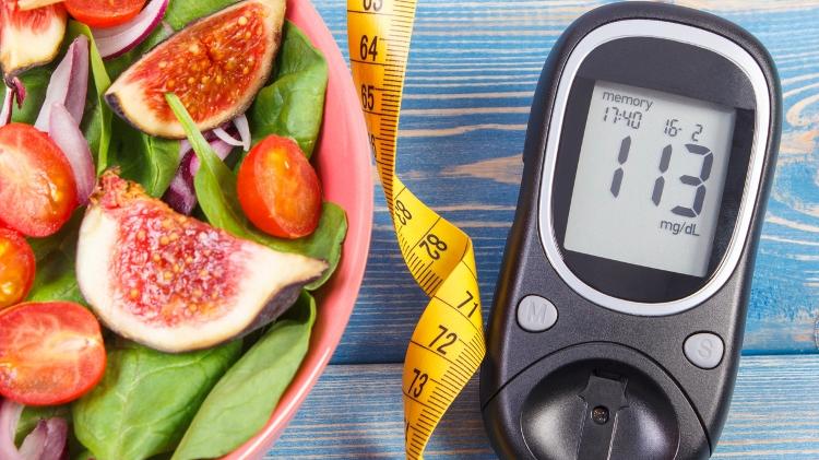 Fruit and vegetable salad and glucose meter with tape measure, concept of diabetes, slimming and healthy nutrition - iStock - iStock