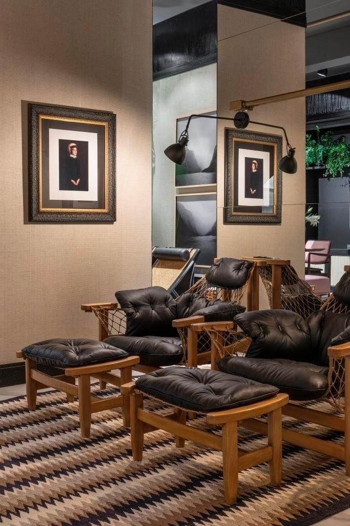 Um dos espaços do Loft 9, assinado por Ana Paula de Castro e Sanderson Porto, tem paredes revestidas com palha natural. A decoração se baseia em tons terrosos na madeira e no tapete em zigue-zague. As poltronas e pufes são estruturados com redes e têm almofadões com acabamento em couro. A criação computa uma área de 85 m² - Jomar Bragança/Divulgação