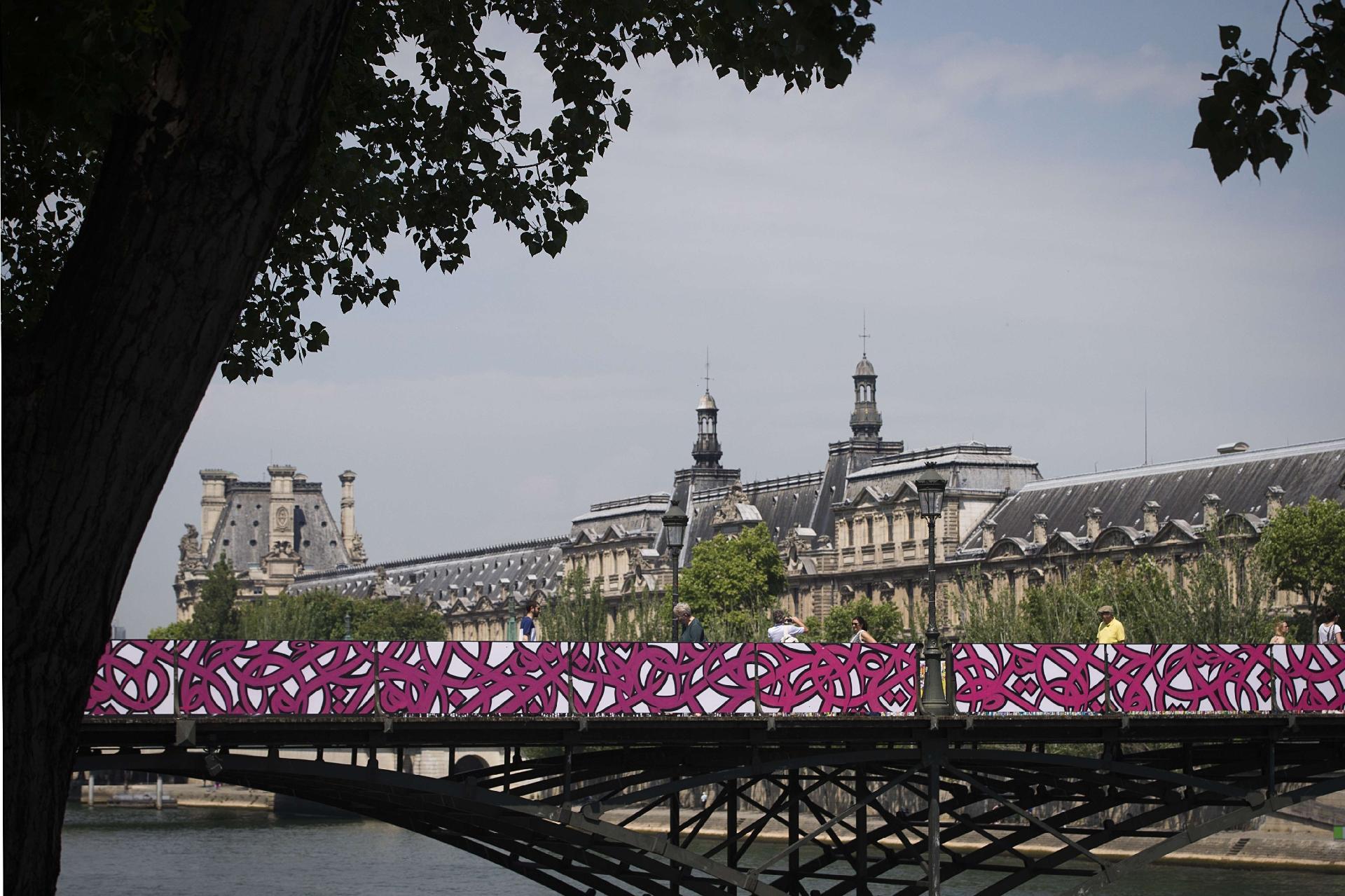 As obras do artista El Seed enfeitaram a Pont des Arts ao lado do Louvre enquanto seus famosos cadeados do amor eram retirados - JOEL SAGET/AFP
