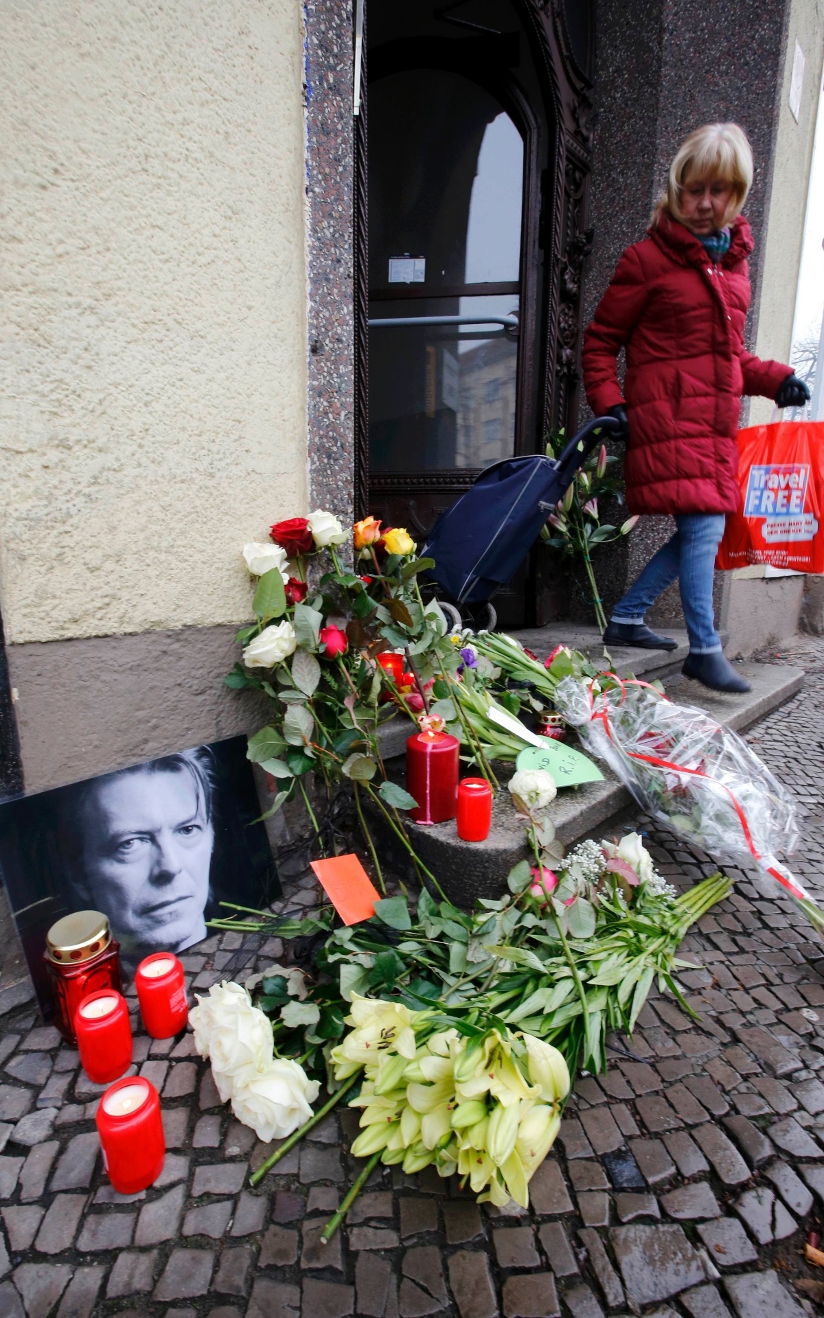 11.jan.2016 - Flores e velas são acesas ao lado de um retrato de David Bowie deixado por fãs em frente ao apartamento onde o cantor morava, em Schoeneberg, em Berlim, na Alemanha - Fabrizio Bensch/Reuters