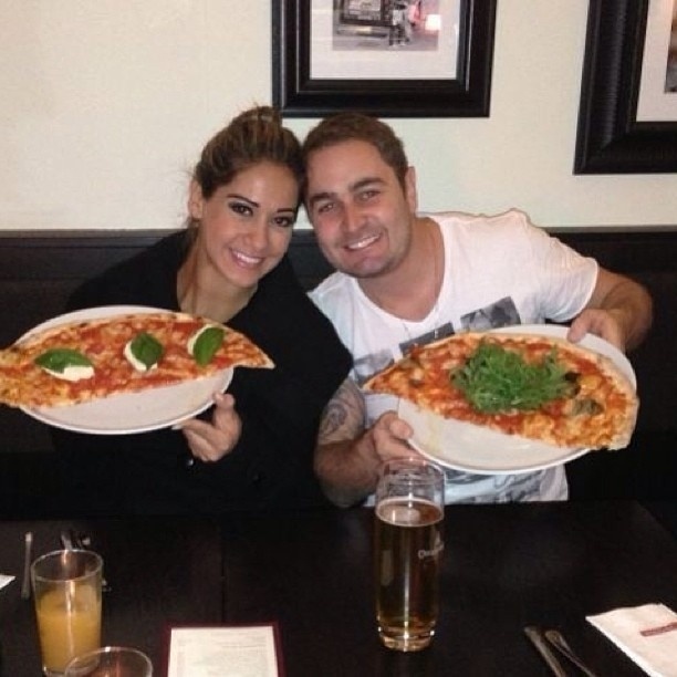 3.jun.2013 - Mayra Cardi come pizza com o marido na Áustria
