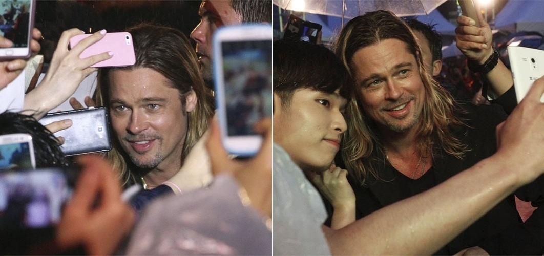 11.jun.2013 - Astro de "World War Z", Brad Pitt é cercado por fãs em Seul, capital da Coreia do Sul, durante a pré-estreia do filme no país. Pitt aterrissa no Rio de Janeiro, com Jolie os filhos, na próxima semana