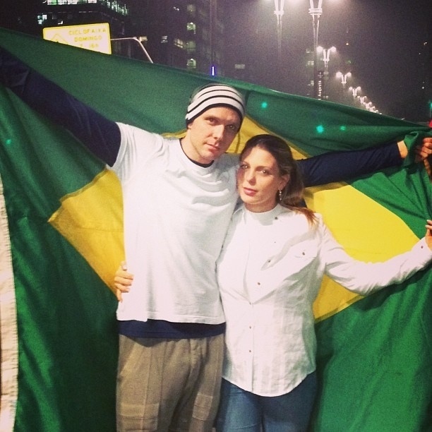 20.jun.2013 - Em São Paulo, o casal formado por Fernando Scherer e Sheilla Mello levou uma bandeira do Brasil