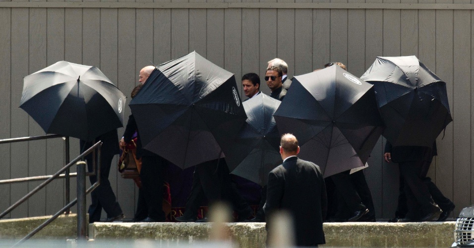 27.jun.2013 - Homens usam guarda-chuvas para evitar que caixão do ator James Gandolfini seja fotografado após o fim do funeral, que aconteceu na Cathedral Church of St. John the Divine, em Nova York