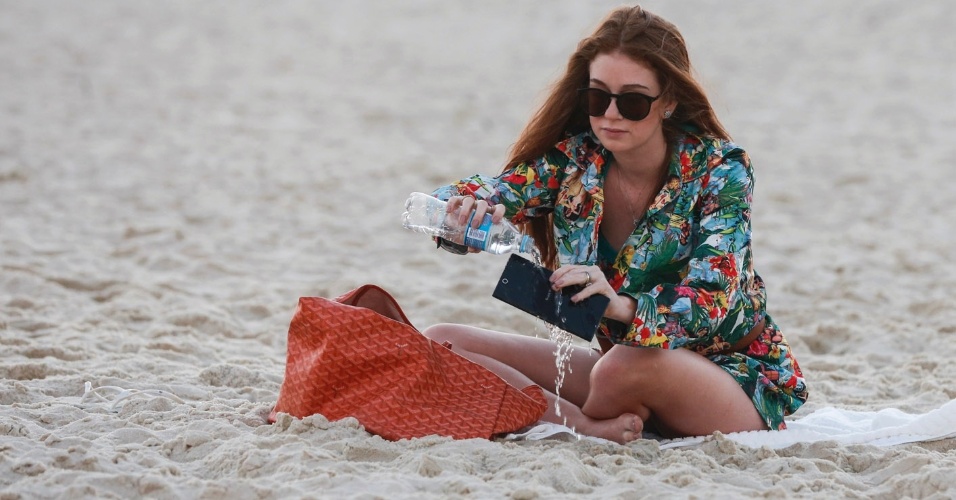 19.jul.2013 - Depois da polêmica em torno de seu cabelo, Marina Ruy Barbosa vai à praia sozinha e "lava celular"