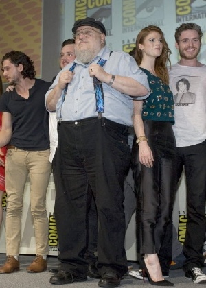 O escritor George R. R. Martin sobe ao palco com o elenco de "Game of Thrones" no painel do programa na Comic-Con