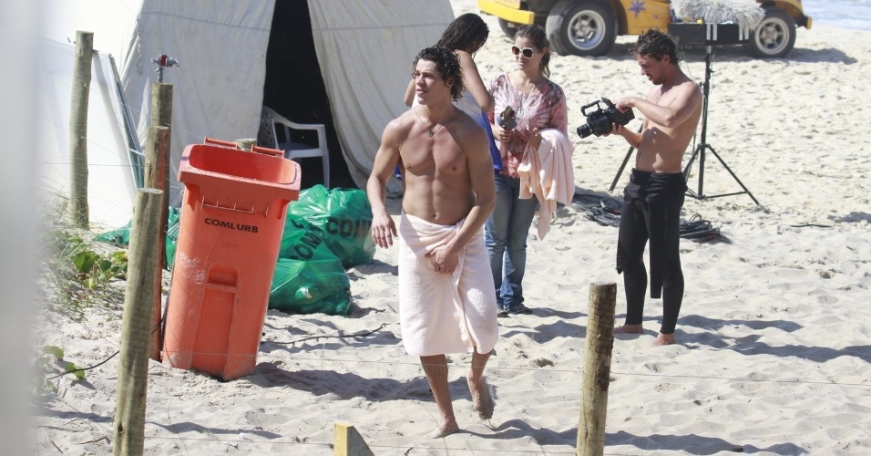 6.ago.2013 - José Loreto ajeita a toalha e exibe músculos durante gravação de "Flor do Caribe" na Prainha, no Rio de Janeiro.. Na trama, ele é Candinho