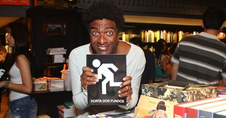8.ago.2013 - O humorista 8.ago.2013 - O humorista Hélio de la Peña posa com o livro do "Porta dos Fundos" em livraria do Rio de Janeiro